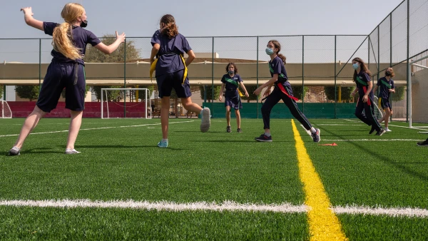 Secondary girls playing flag football