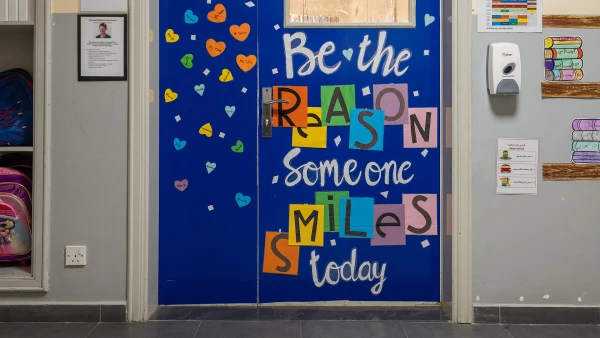 wellspring private school elementary Classroom door decorated with 'Be the reason someone smiles today'