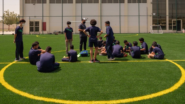 Secondary students on the pitch learning at The WellSpring Private School about soccer and pe